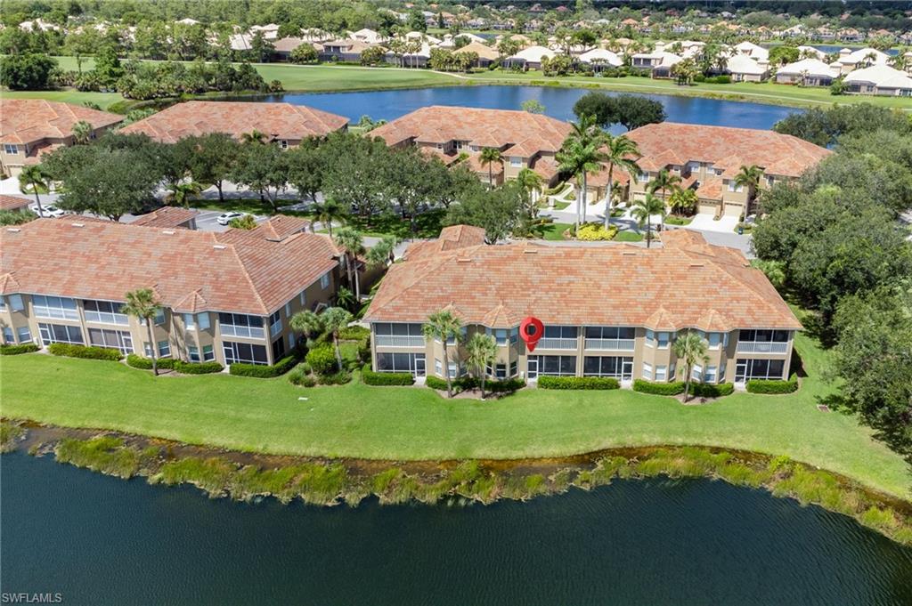 20031 Seagrove Street, Unit 1403 Estero, FL 33928 - Photo 20 of 28 an aerial view of a house with a garden and lake view