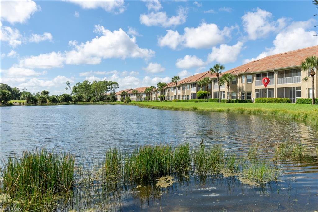 20031 Seagrove Street, Unit 1403 Estero, FL 33928 - Photo 21 of 28 a view of a lake with a building in the background