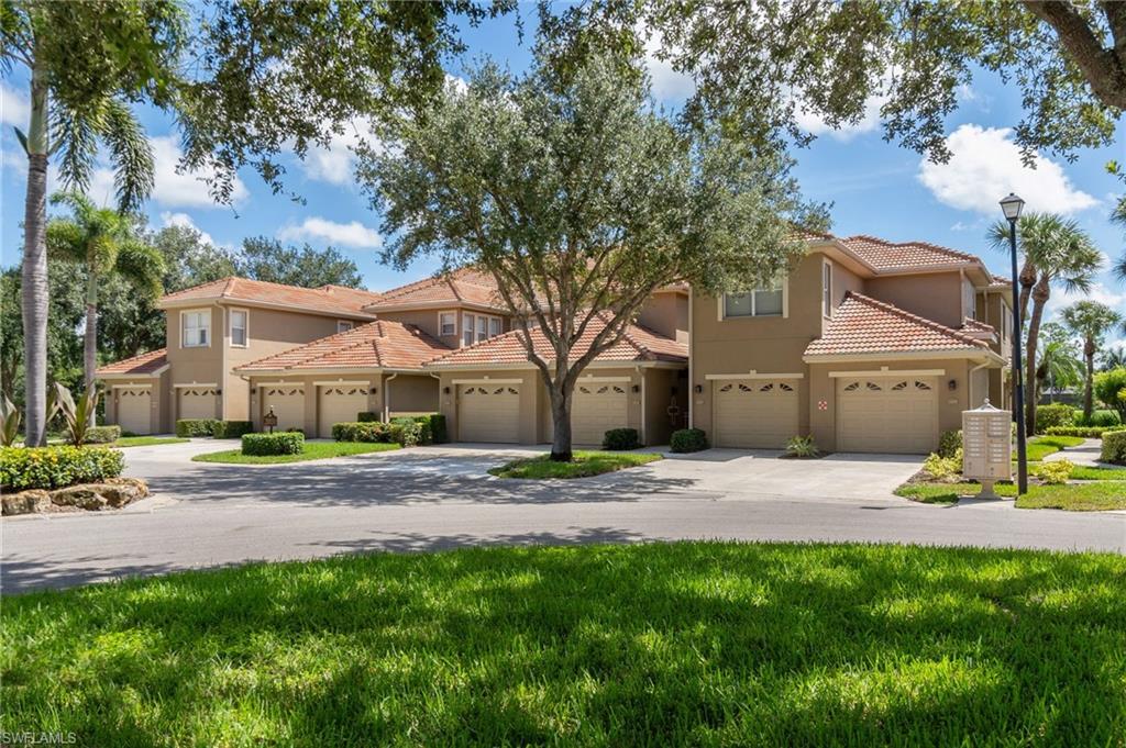 20031 Seagrove Street, Unit 1403 Estero, FL 33928 - Photo 3 of 28 a small house with a tree in front of it