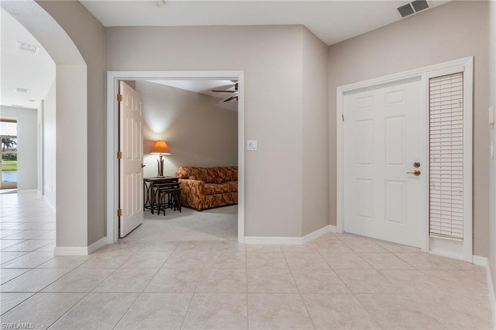 20031 Seagrove Street, Unit 1403 Estero, FL 33928 - Photo 10 of 28 a view of a room that has a bed and a large mirror