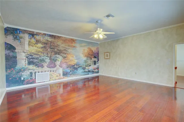 a view of a big room with wooden floor and large window