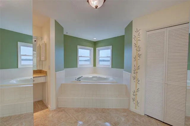 a bathroom with a tub sink and a mirror