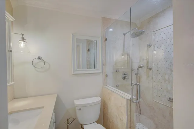 a bathroom with a toilet a sink and shower