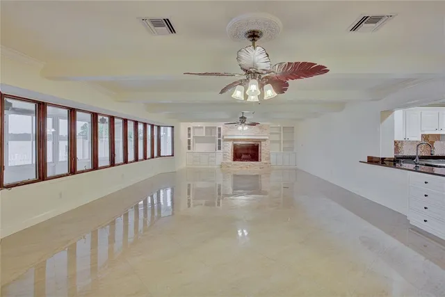 a view of an empty room and kitchen view