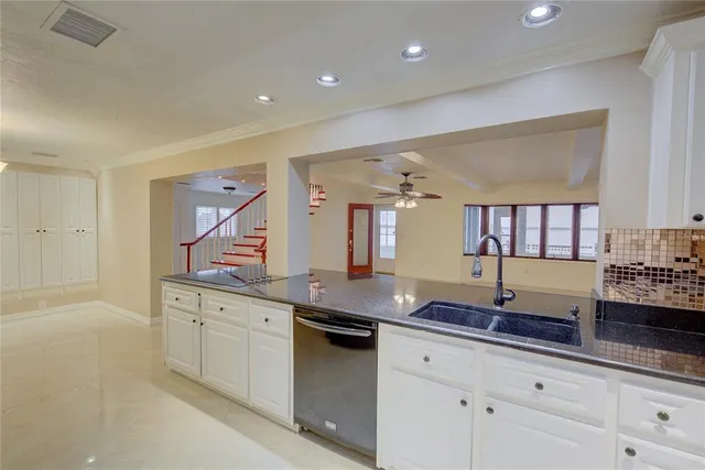 a kitchen with granite countertop a sink and cabinets