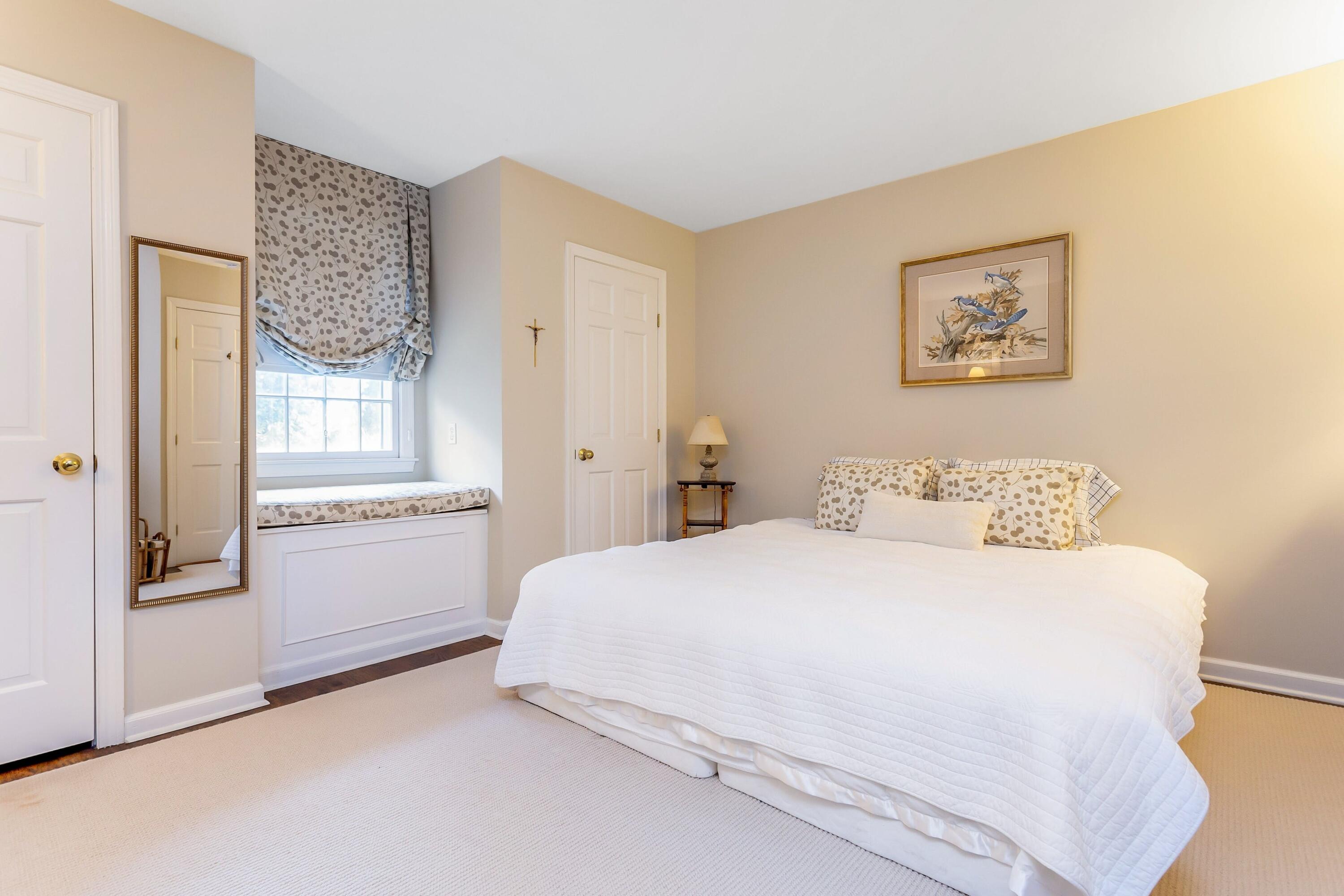 9 Peterick Lane Darien, CT 06820 - Photo 23 of 28 a bedroom with a bed and a painting on the wall
