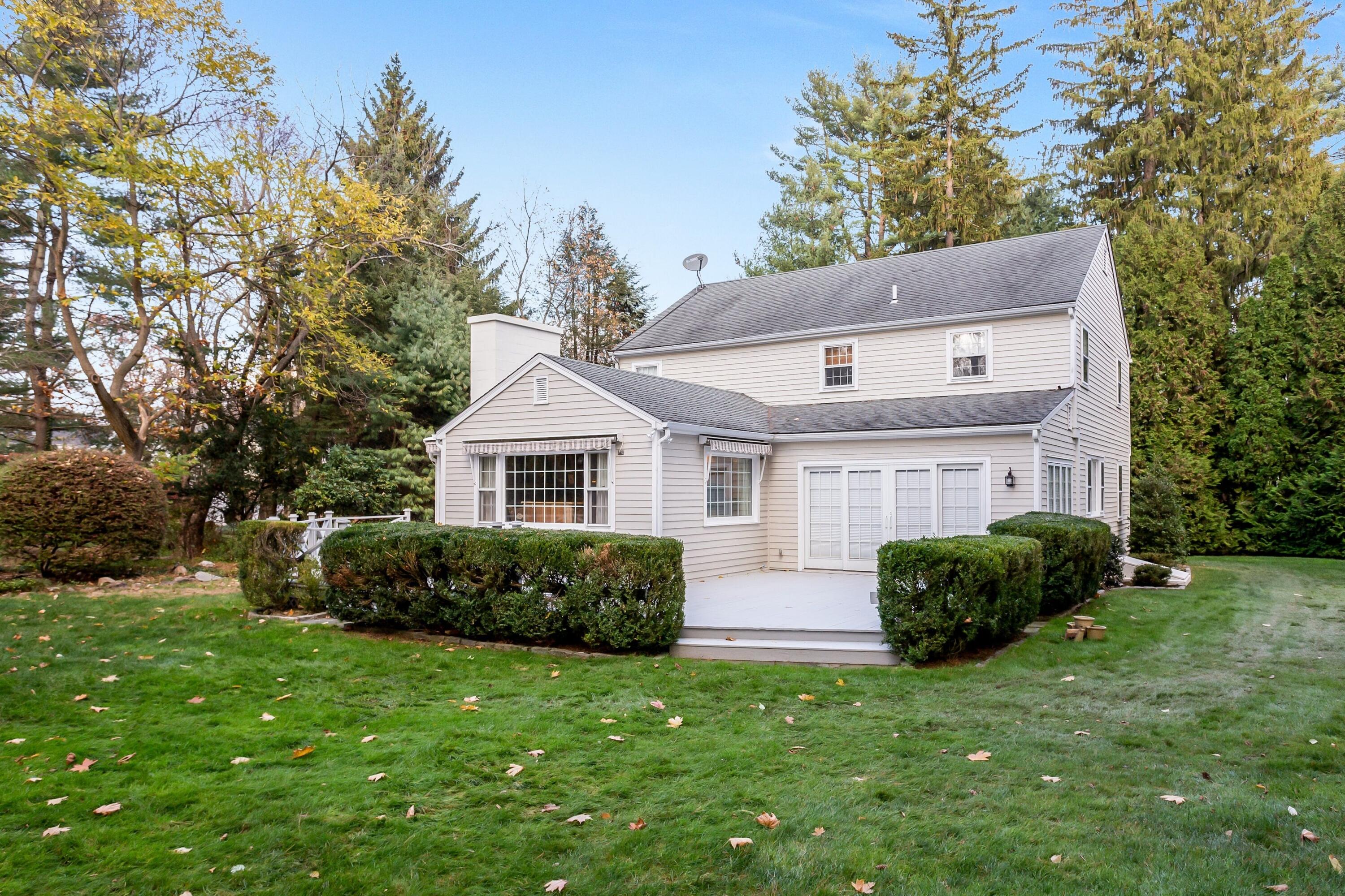 9 Peterick Lane Darien, CT 06820 - Photo 25 of 28 a front view of a house with a garden