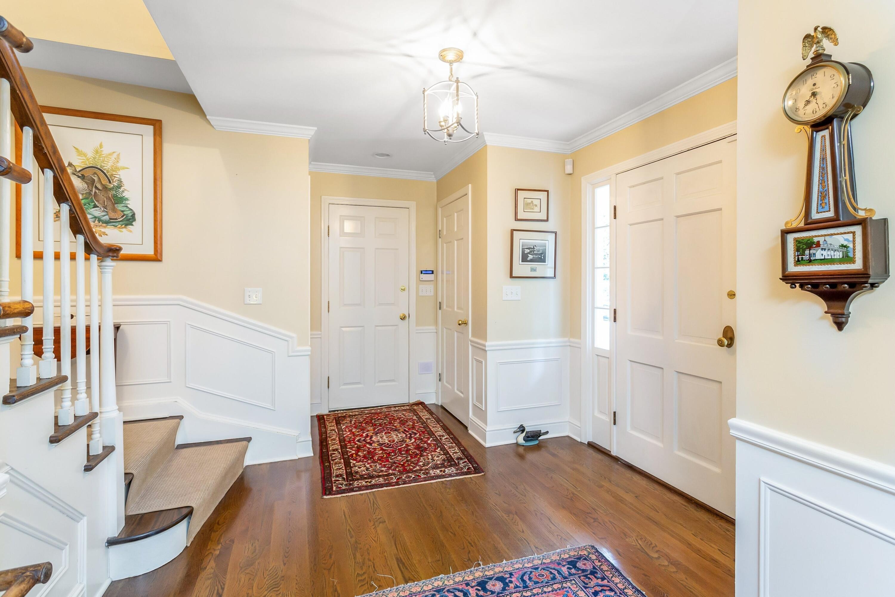 9 Peterick Lane Darien, CT 06820 - Photo 4 of 28 a bedroom with a bed and a chandelier