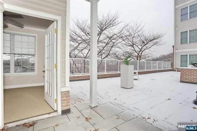 a view of house with a large window and wooden fence