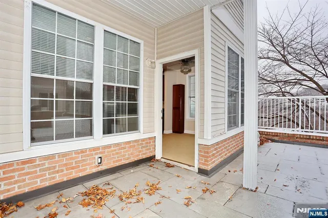 a kitchen with stainless steel appliances granite countertop a refrigerator a stove and a sink with wooden floor