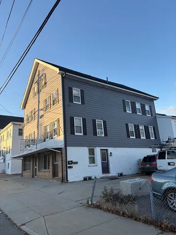 a front view of a building with parking space