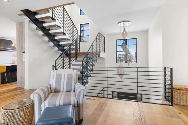 a living room with stainless steel appliances granite countertop furniture and a kitchen view