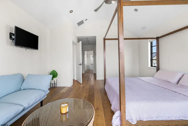 a view of a patio with table and chairs with wooden floor and fence