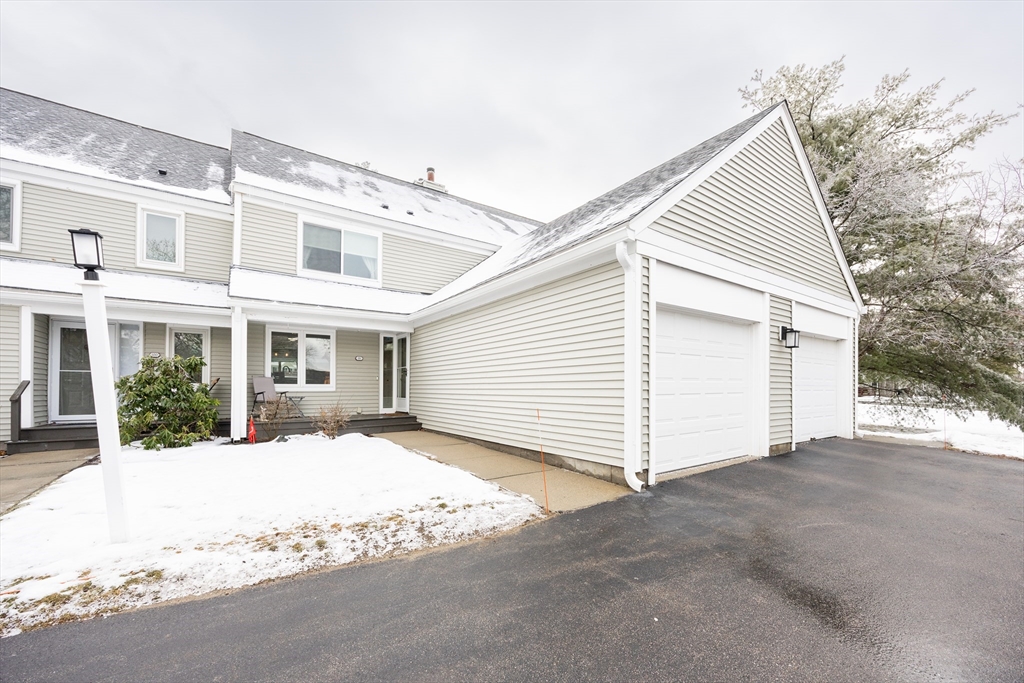 99 Stone Ridge Road, Unit 99 Franklin, MA 02038 - Photo 1 of 39 a view of a white house with a outdoor space