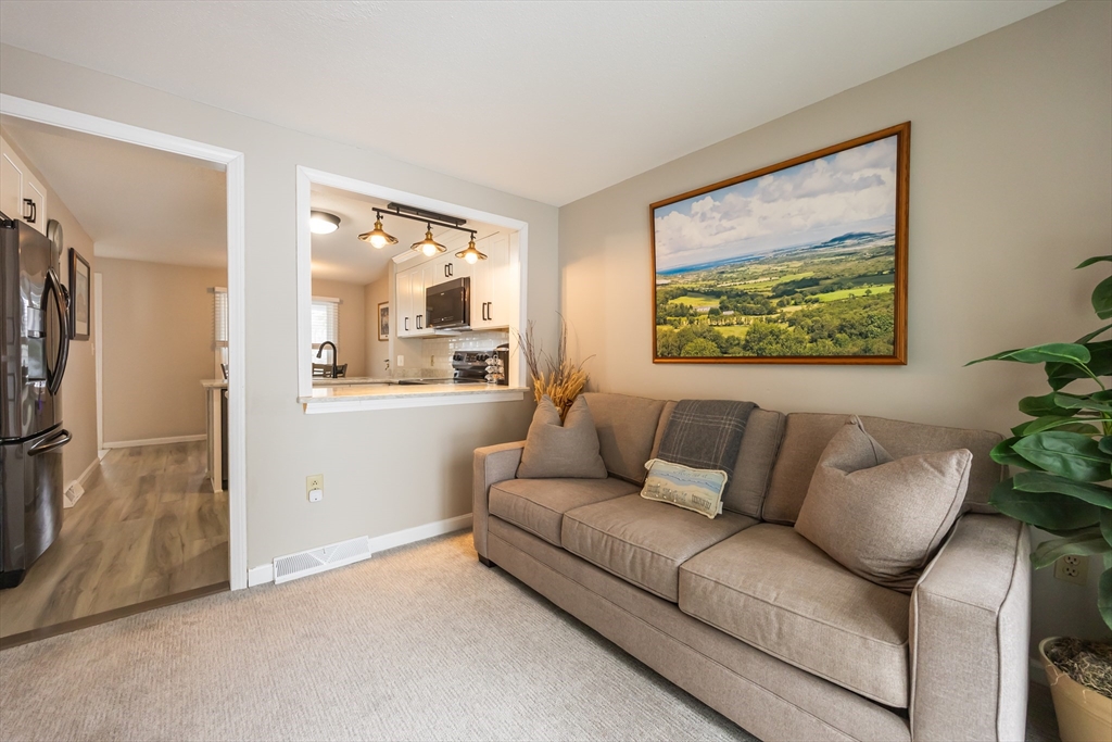 99 Stone Ridge Road, Unit 99 Franklin, MA 02038 - Photo 12 of 39 a living room with furniture and a large window