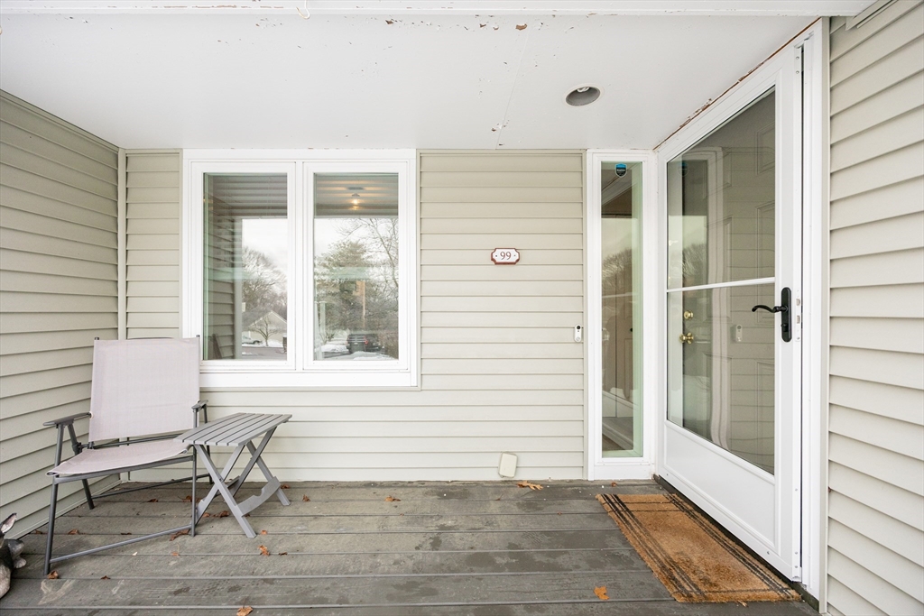 99 Stone Ridge Road, Unit 99 Franklin, MA 02038 - Photo 2 of 39 a chair and a table in a room