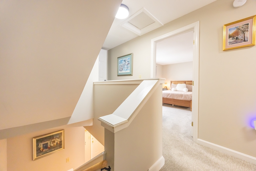 99 Stone Ridge Road, Unit 99 Franklin, MA 02038 - Photo 21 of 39 a view of a bedroom with wooden floor and window