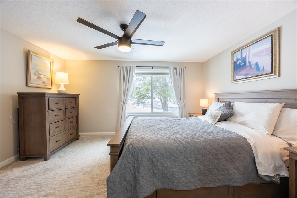 99 Stone Ridge Road, Unit 99 Franklin, MA 02038 - Photo 29 of 39 a bed room with a bed and a window