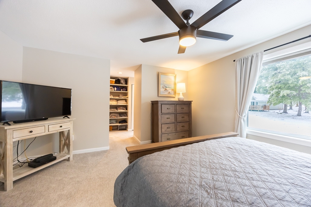 99 Stone Ridge Road, Unit 99 Franklin, MA 02038 - Photo 30 of 39 a bedroom with a bed and a flat screen tv