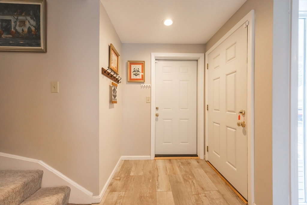 99 Stone Ridge Road, Unit 99 Franklin, MA 02038 - Photo 3 of 39 a view of a hallway with wooden floor and closet