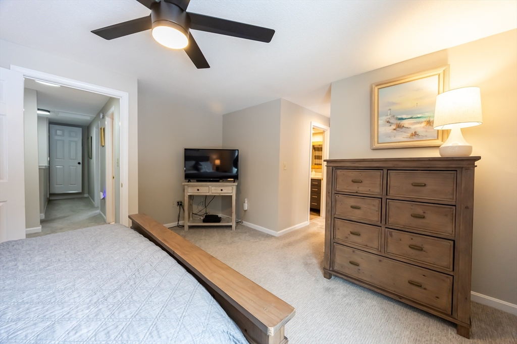99 Stone Ridge Road, Unit 99 Franklin, MA 02038 - Photo 31 of 39 a bedroom with a bed and a television