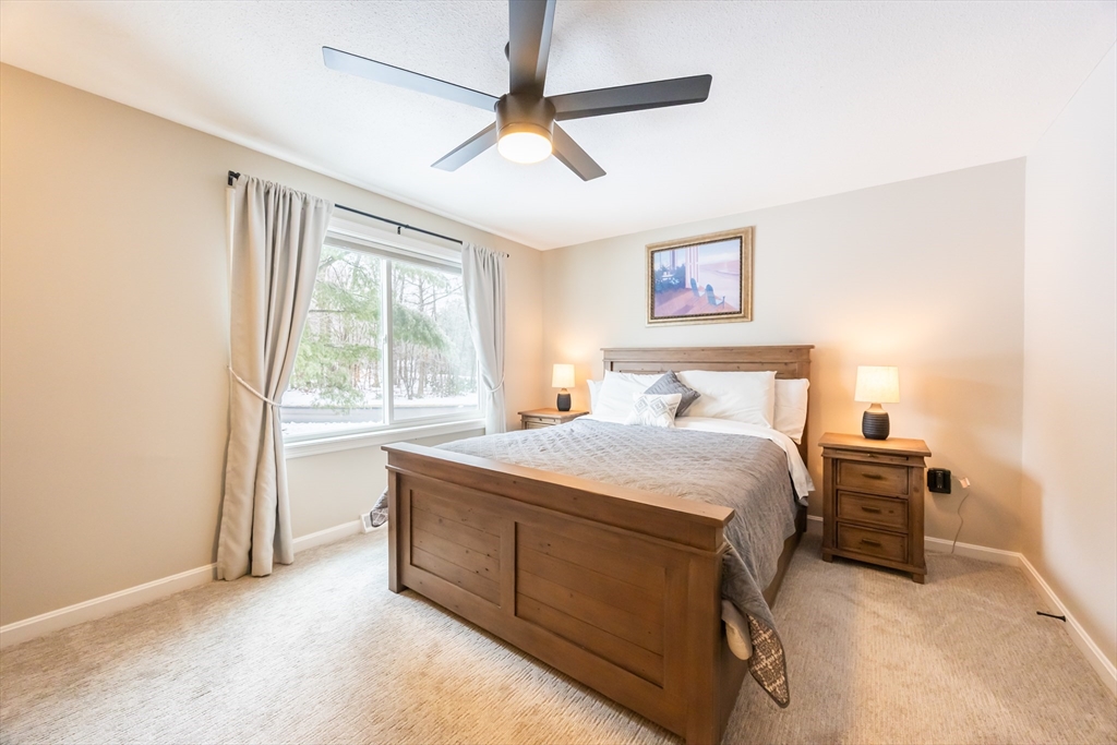 99 Stone Ridge Road, Unit 99 Franklin, MA 02038 - Photo 32 of 39 a bedroom with a bed and a window