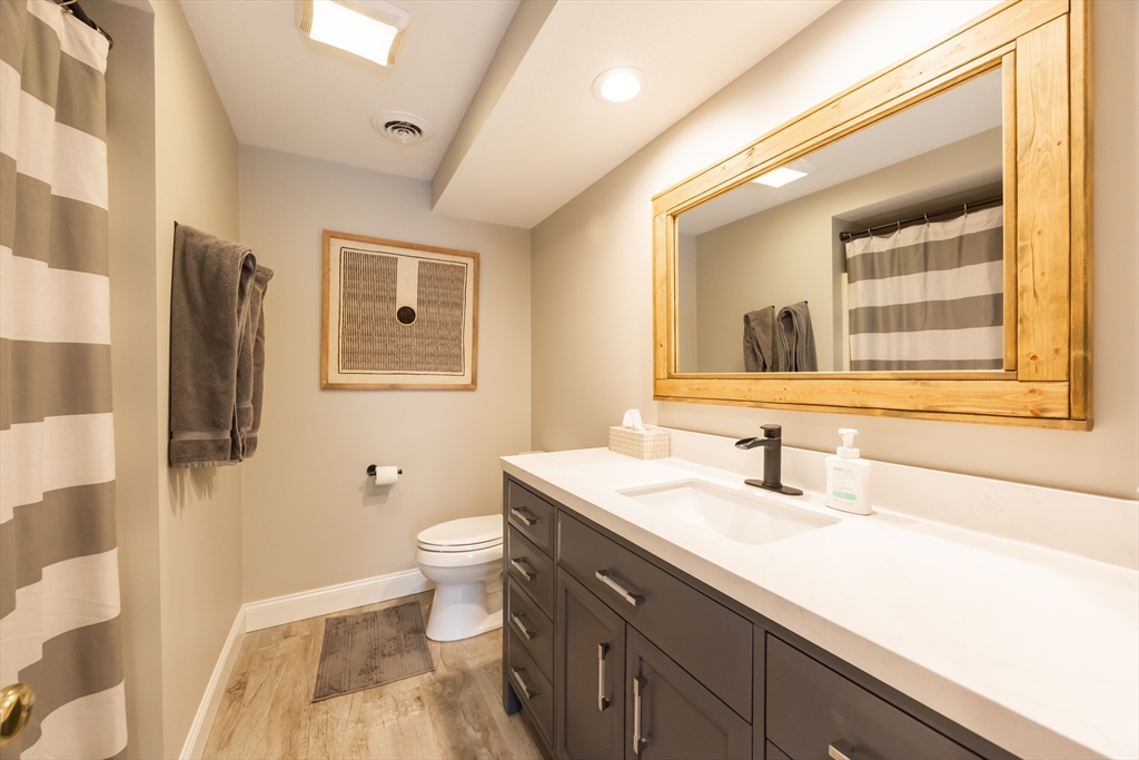 99 Stone Ridge Road, Unit 99 Franklin, MA 02038 - Photo 34 of 39 a bathroom with a sink a toilet and a mirror