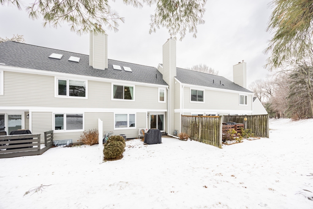 99 Stone Ridge Road, Unit 99 Franklin, MA 02038 - Photo 35 of 39 a front view of a house with a yard covered in snow