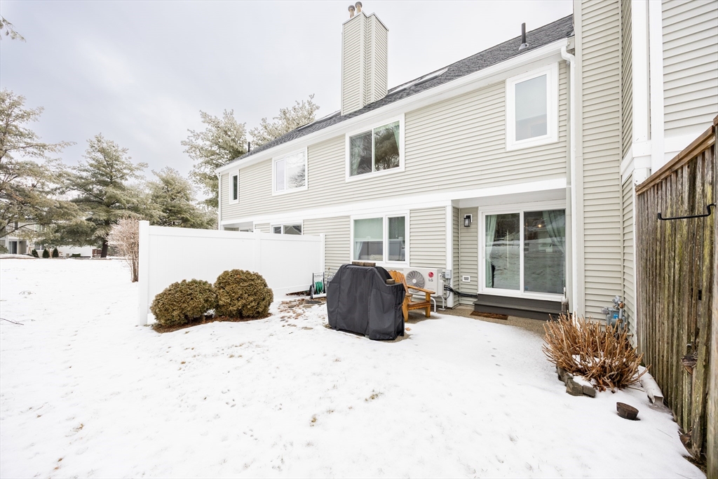 99 Stone Ridge Road, Unit 99 Franklin, MA 02038 - Photo 36 of 39 a view of a house with a yard covered in snow