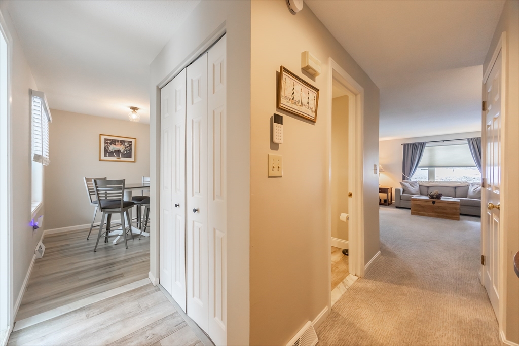 99 Stone Ridge Road, Unit 99 Franklin, MA 02038 - Photo 5 of 39 a view of a livingroom from a hallway