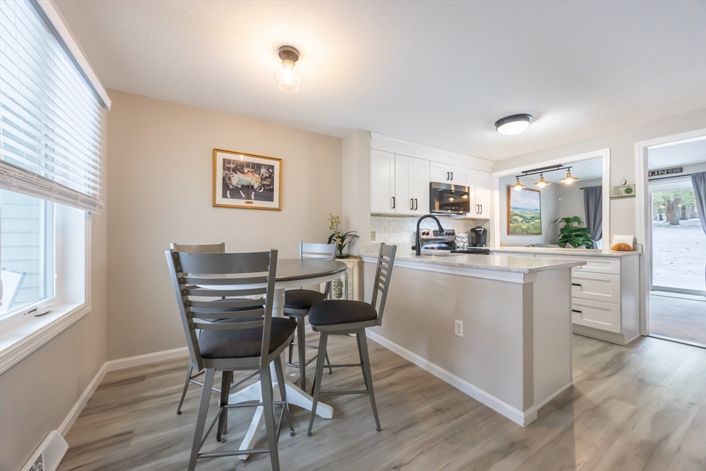 99 Stone Ridge Road, Unit 99 Franklin, MA 02038 - Photo 6 of 39 a kitchen with a table and chairs in it
