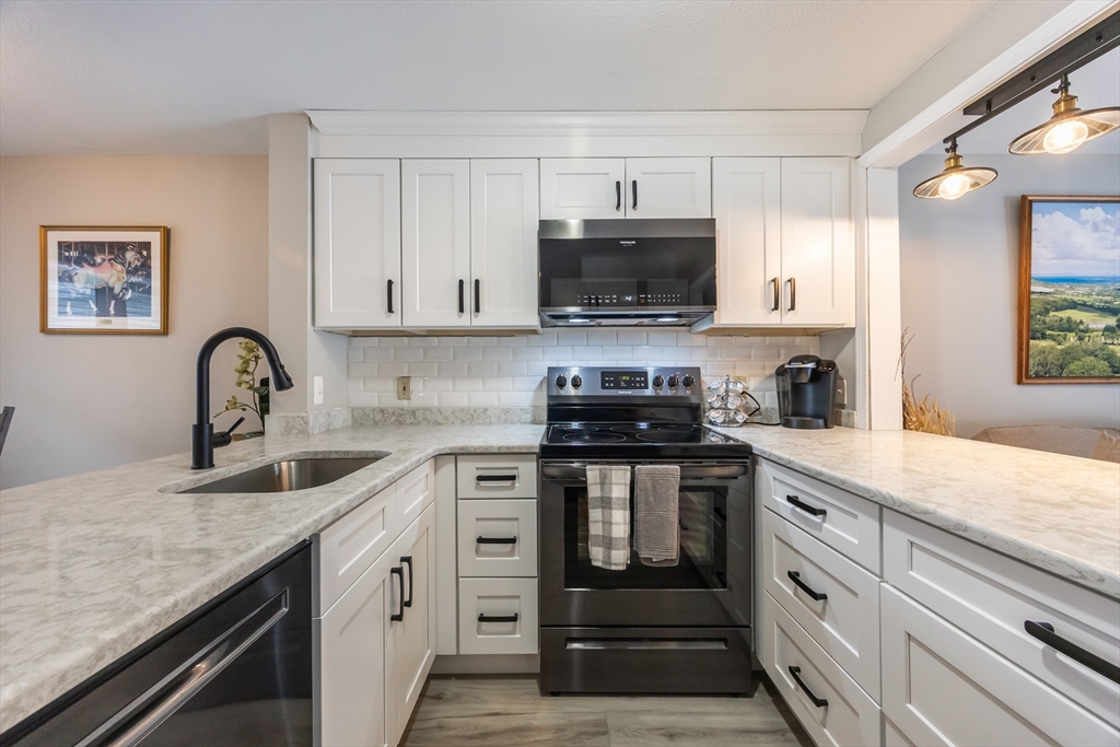 99 Stone Ridge Road, Unit 99 Franklin, MA 02038 - Photo 8 of 39 a kitchen with sink a stove and cabinets