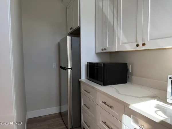 a bathroom with a granite countertop sink a mirror and a