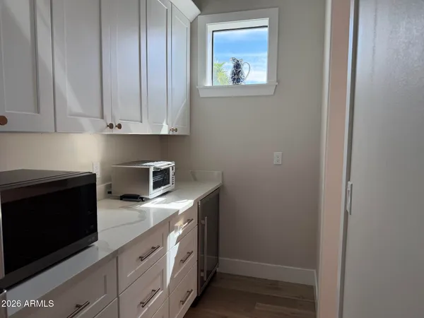 a bathroom with a toilet a sink a vanity and mirror