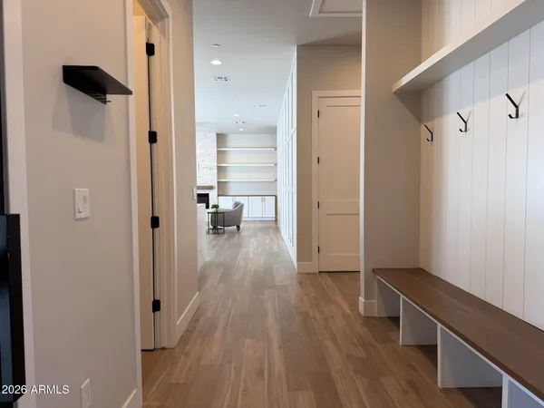 a kitchen with stainless steel appliances granite countertop a sink a microwave a refrigerator and chairs