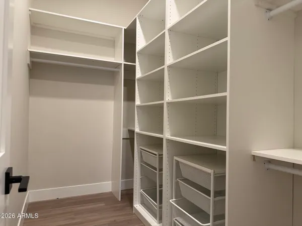 a view of a small space with wooden floor and a window