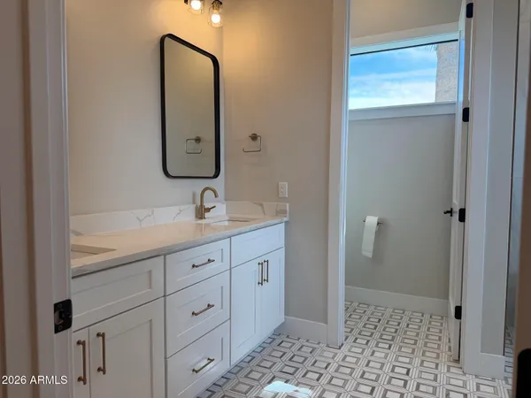 a view of an empty room with wooden floor and a flat screen tv