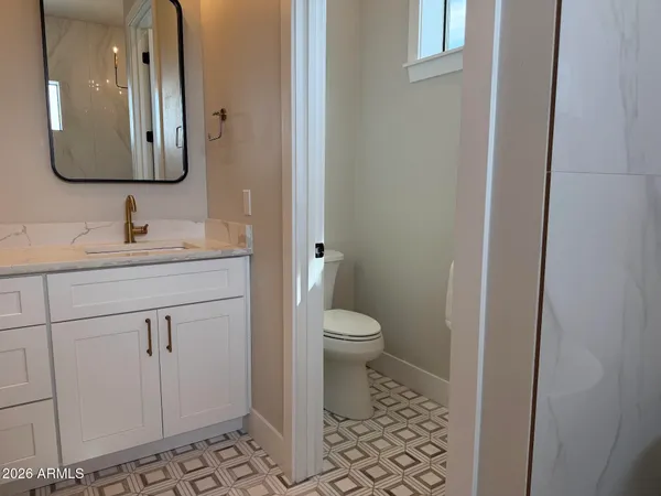 a front view of a house with a garden and yard