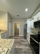 a view of a kitchen with sink refrigerator and stove