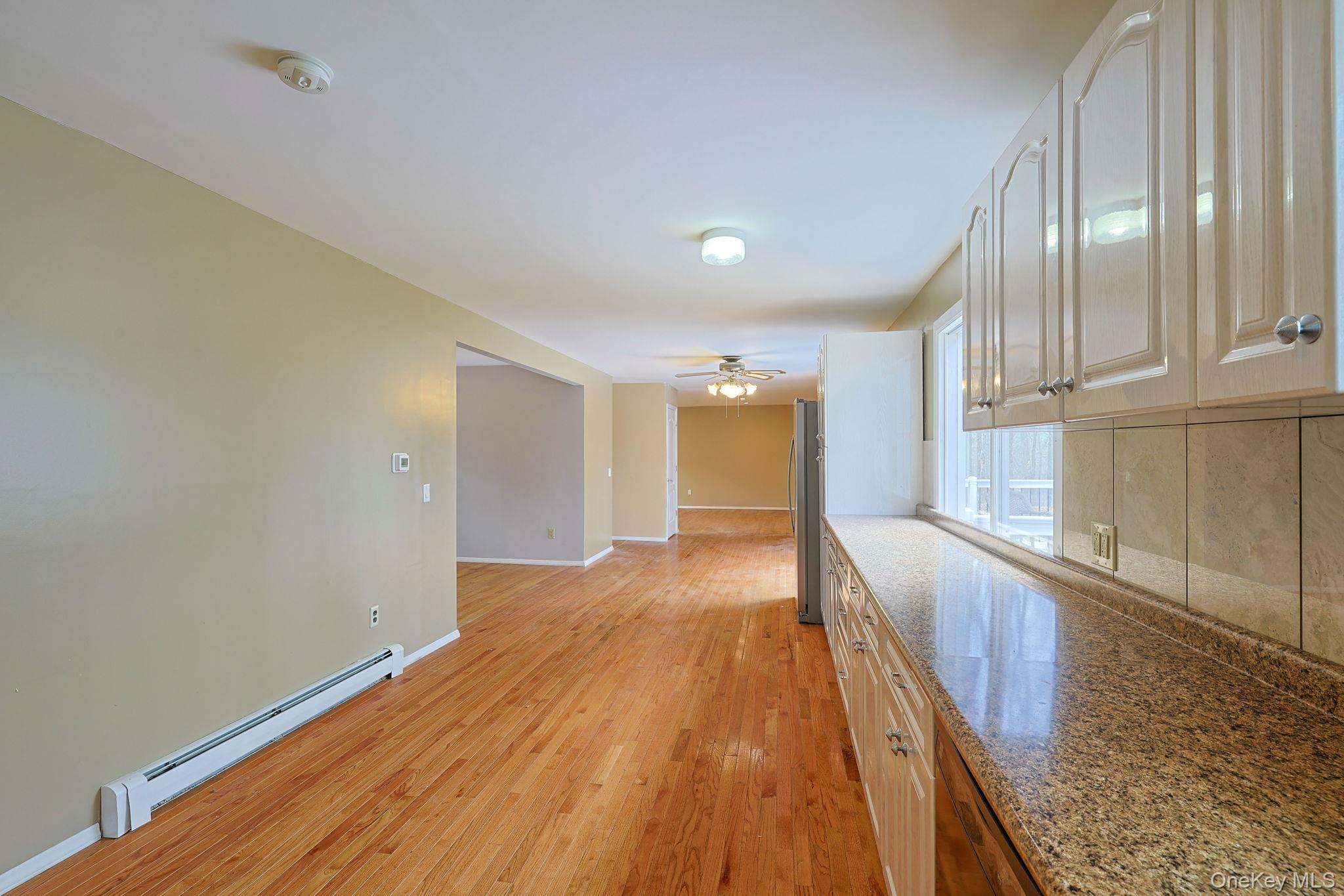 78 Pickerel Road Monroe, NY 10950 - Photo 13 of 41 a view of a kitchen with wooden floor and staircase
