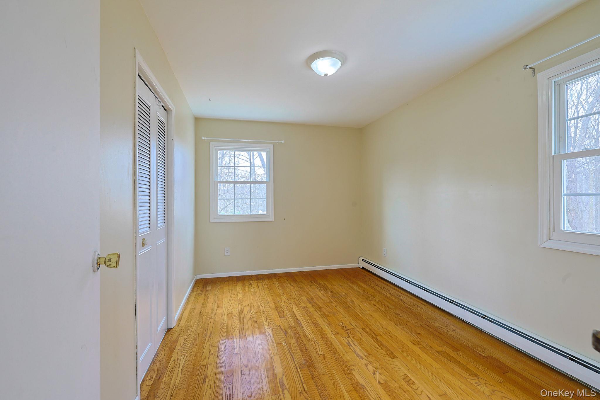 78 Pickerel Road Monroe, NY 10950 - Photo 21 of 41 wooden floor in an empty room with a window
