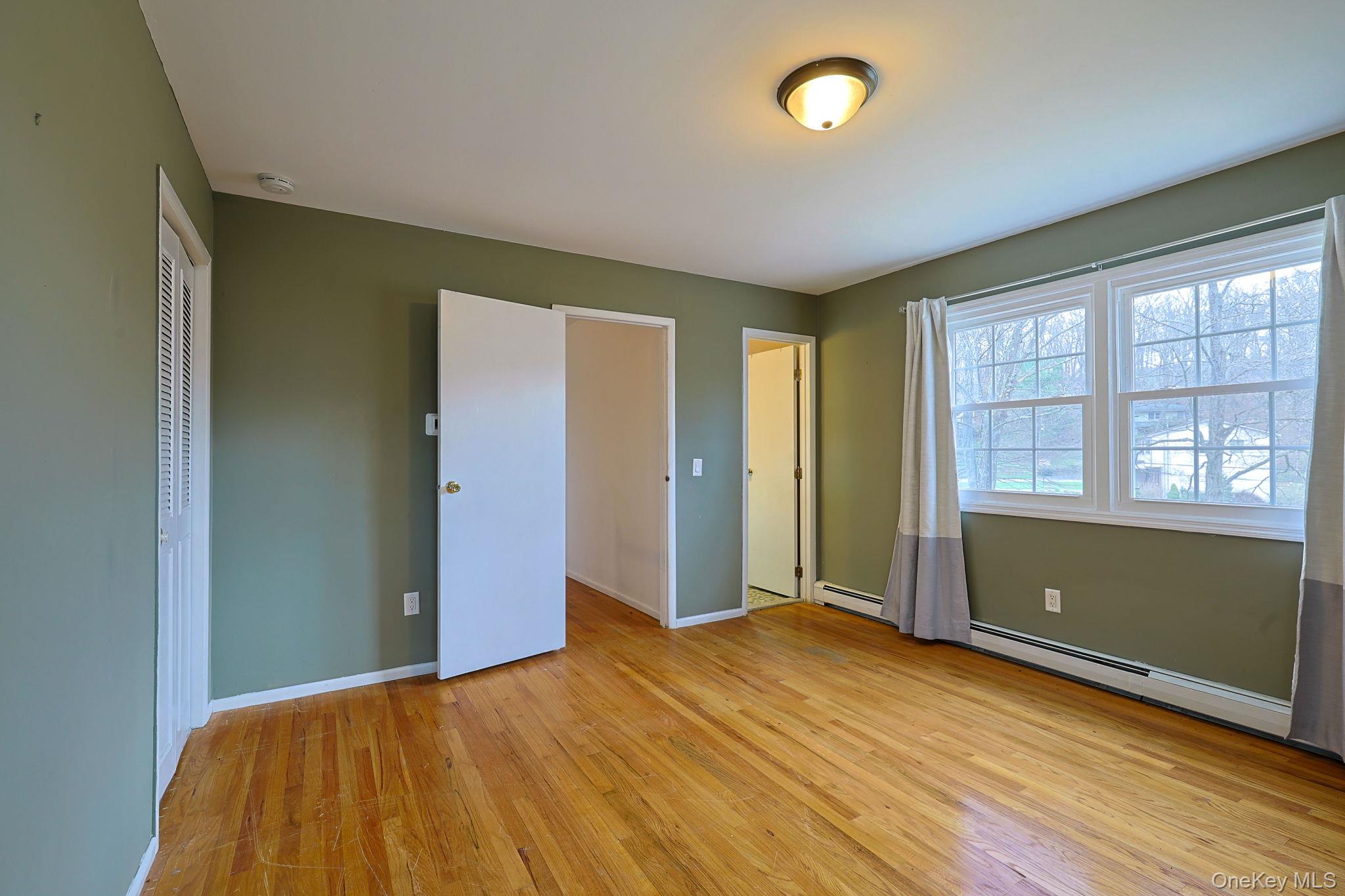 78 Pickerel Road Monroe, NY 10950 - Photo 27 of 41 an empty room with wooden floor and windows