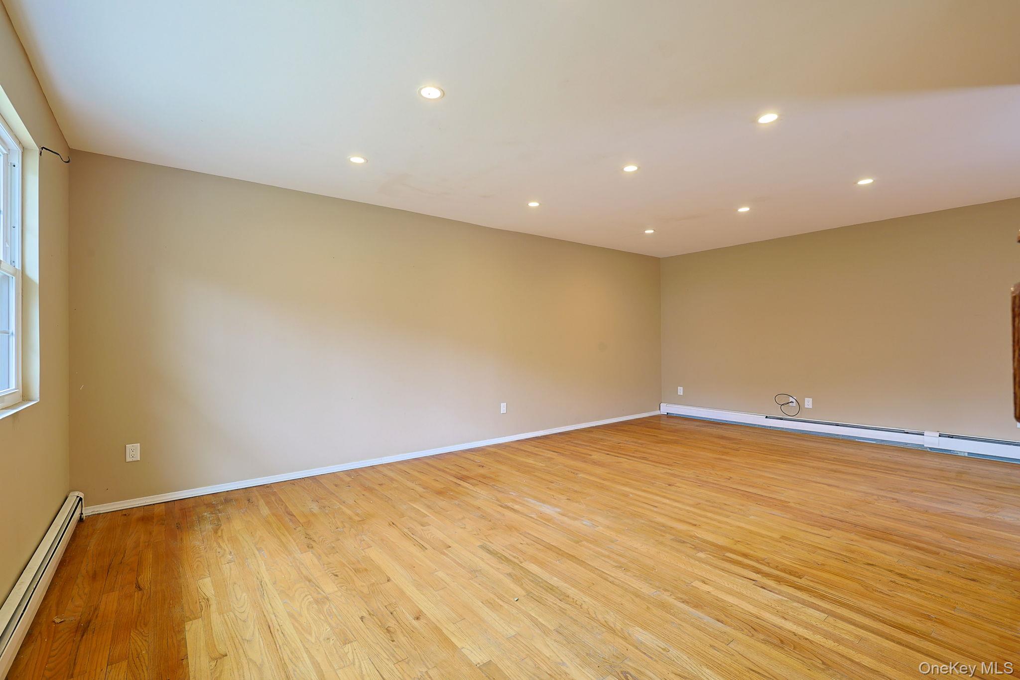 78 Pickerel Road Monroe, NY 10950 - Photo 5 of 41 a view of an empty room with wooden floor and a window