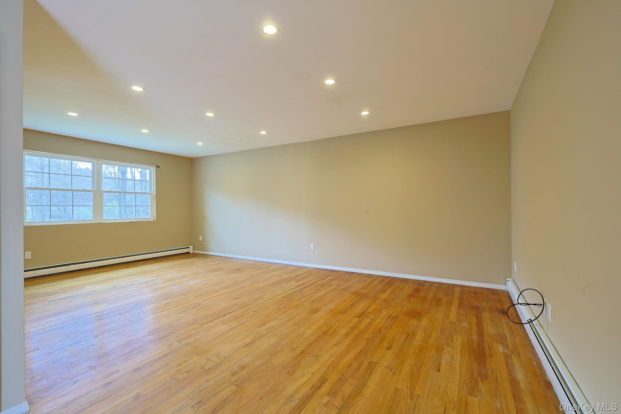 78 Pickerel Road Monroe, NY 10950 - Photo 7 of 41 an empty room with wooden floor and windows
