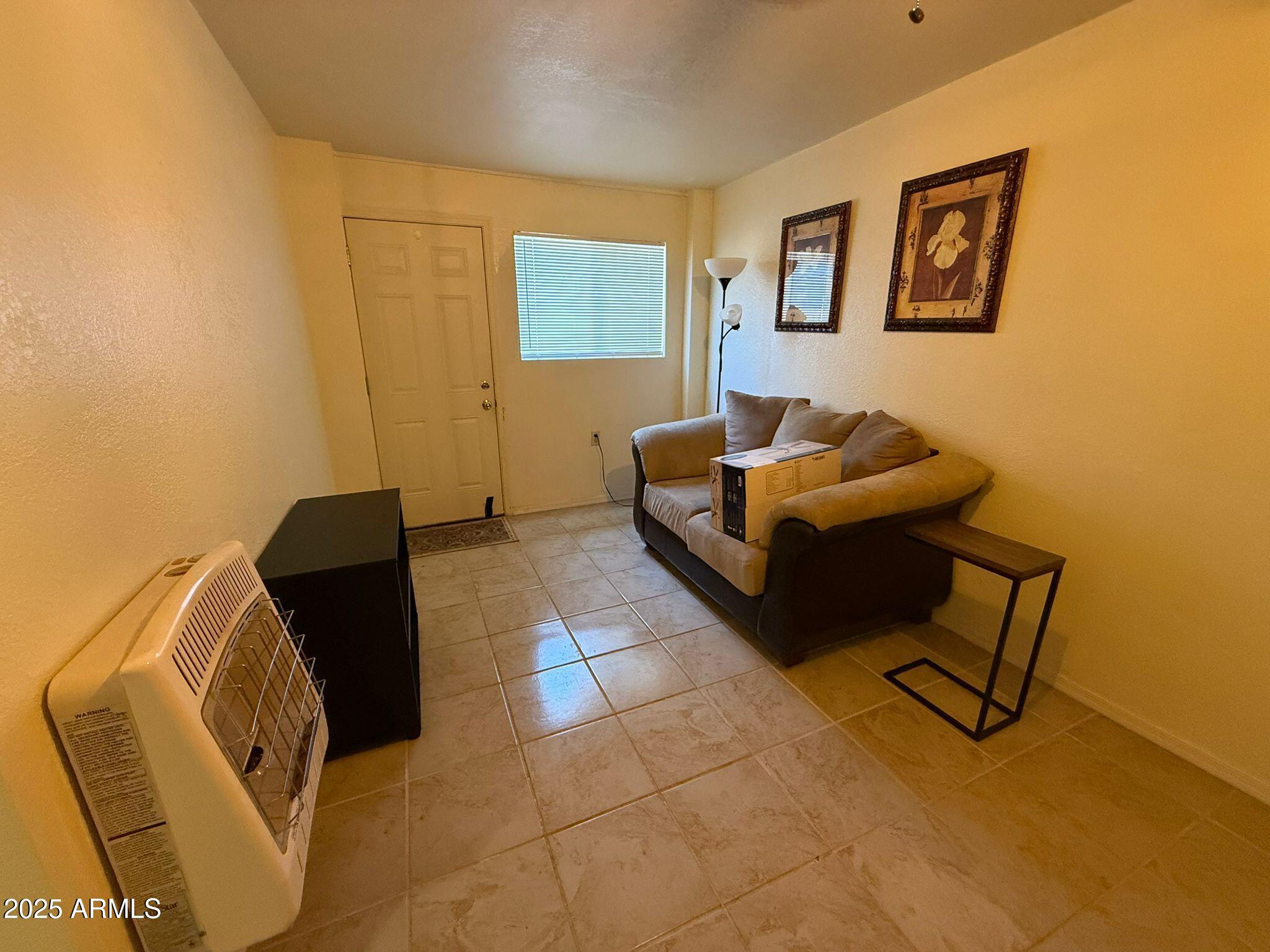 1249 East 10th Street, Unit REAR Douglas, AZ 85607 - Photo 3 of 10 a living room with furniture and a window