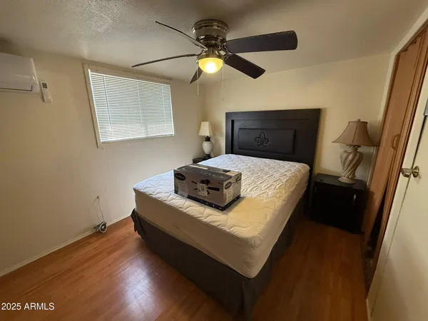 a bedroom with a bed and a ceiling fan