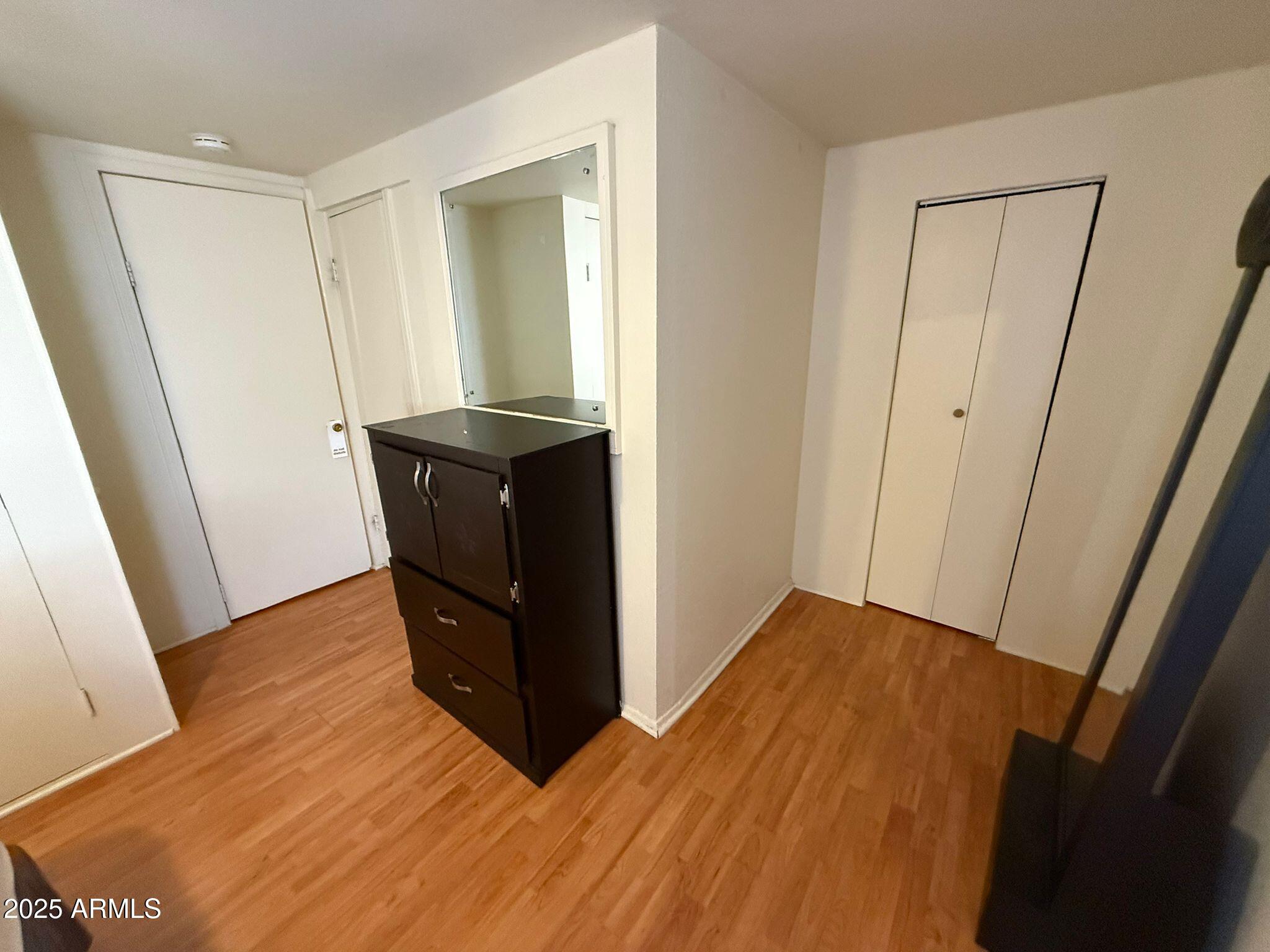 1249 East 10th Street, Unit REAR Douglas, AZ 85607 - Photo 8 of 10 a view of an empty room and wooden floor