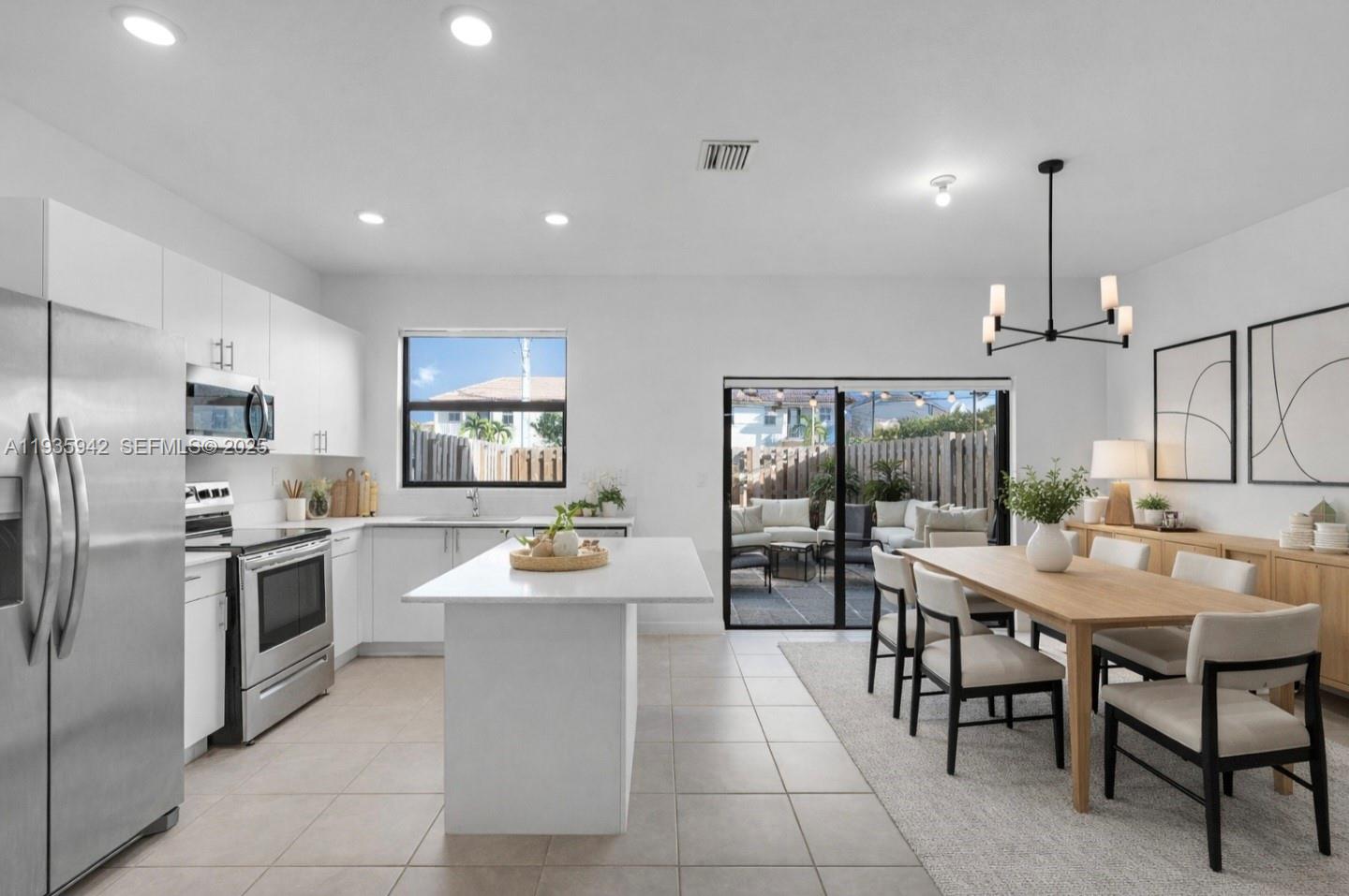 a kitchen with sink cabinets and stainless steel appliances