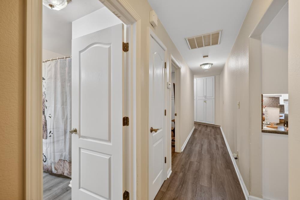 2026 Lily Valley Way West Point, CA 95255 - Photo 28 of 39 a view of a hallway with wooden floor and a bathroom