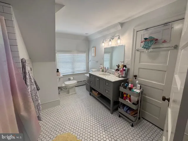 a room with furniture a window and dresser